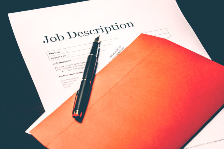 Printed job description form with a pen and a red envelope