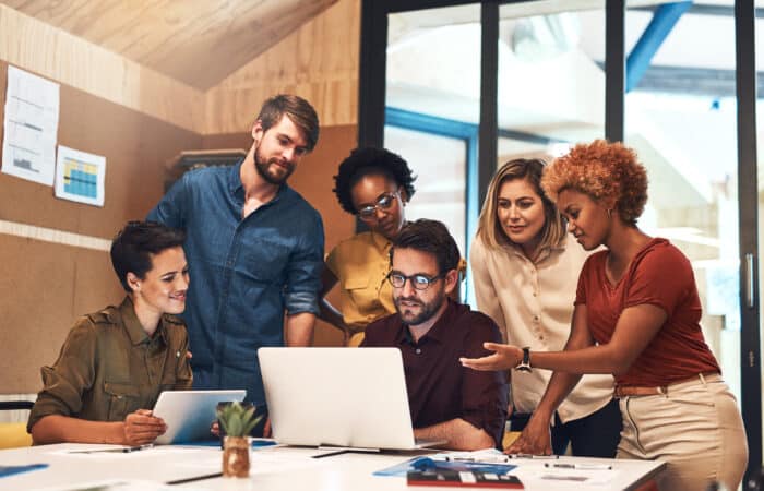 Getting everyone on the same page. Shot of a diverse group of businesspeople working together on a laptop in an office.