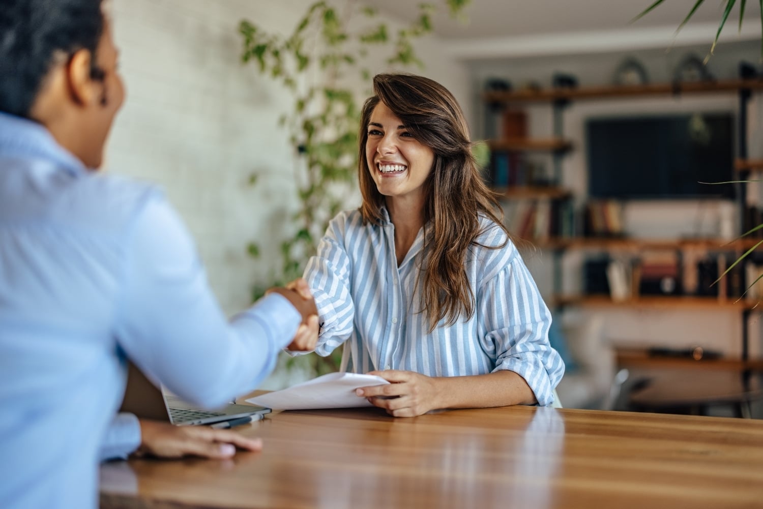 Smiling young woman, finishing with her interview, at the company