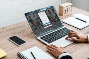 cropped view of woman using laptop with linkedin website near