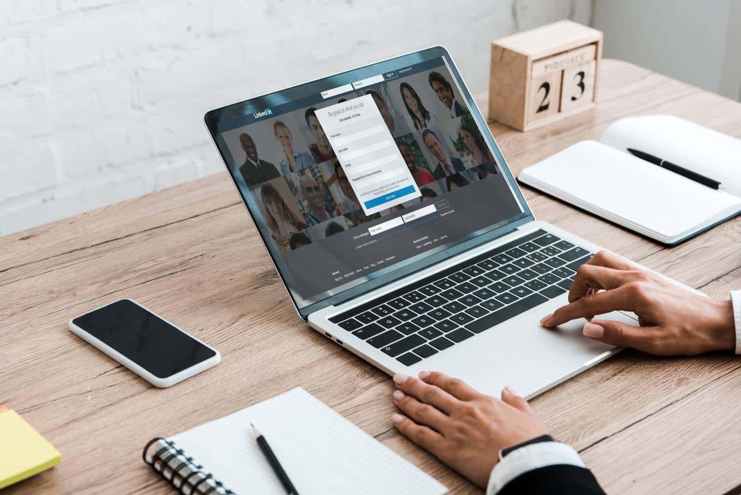 cropped view of woman using laptop with linkedin website near