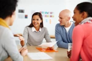 A group of businesspeople discussing work during a meeting