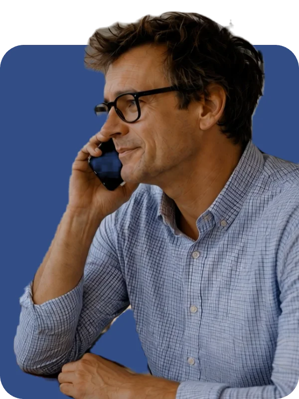 Recruiter in glasses taking a call at his desk